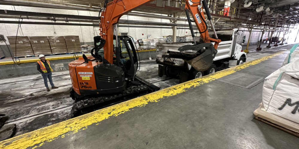 Backhoe Lifting Heavy Rubble