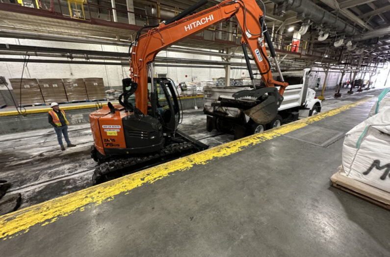 Backhoe Lifting Heavy Rubble